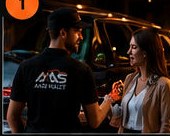 An AAS valet welcomes a guest beside her car.